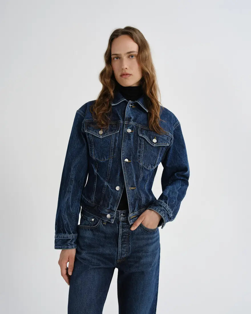 Model in an AGOLDE denim jacket and matching jeans