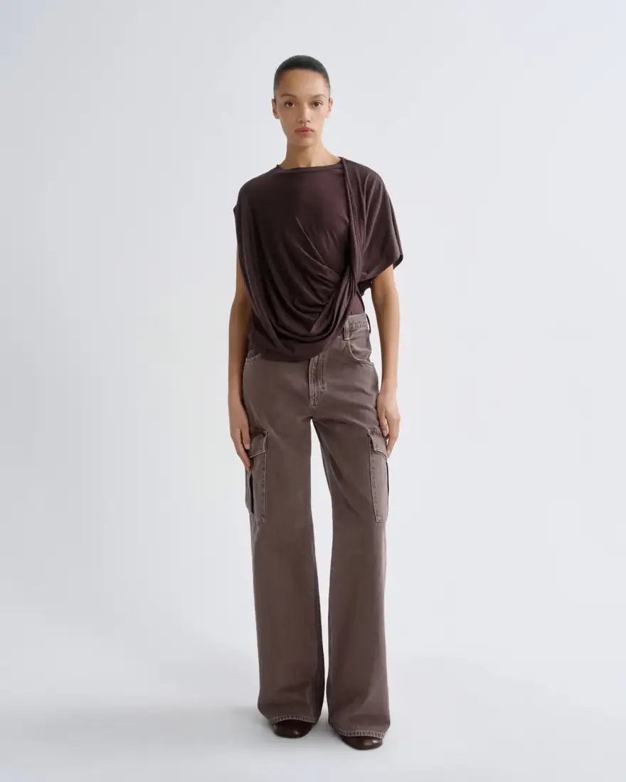 Model in a draped brown top and wide-leg cargo jeans